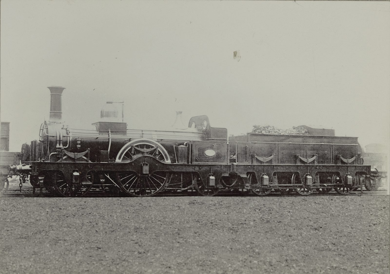 Vintage single-driver steam locomotive with tall driving wheel and tender, built at Ashford Works